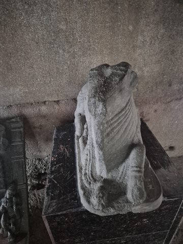 Diagonal folds cross the surviving body of a headless figure. The arms and upper edges are fragmentary.