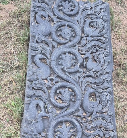 Labelled detail crop showing the curling stems, leaves and small animal forms within the long fragment.